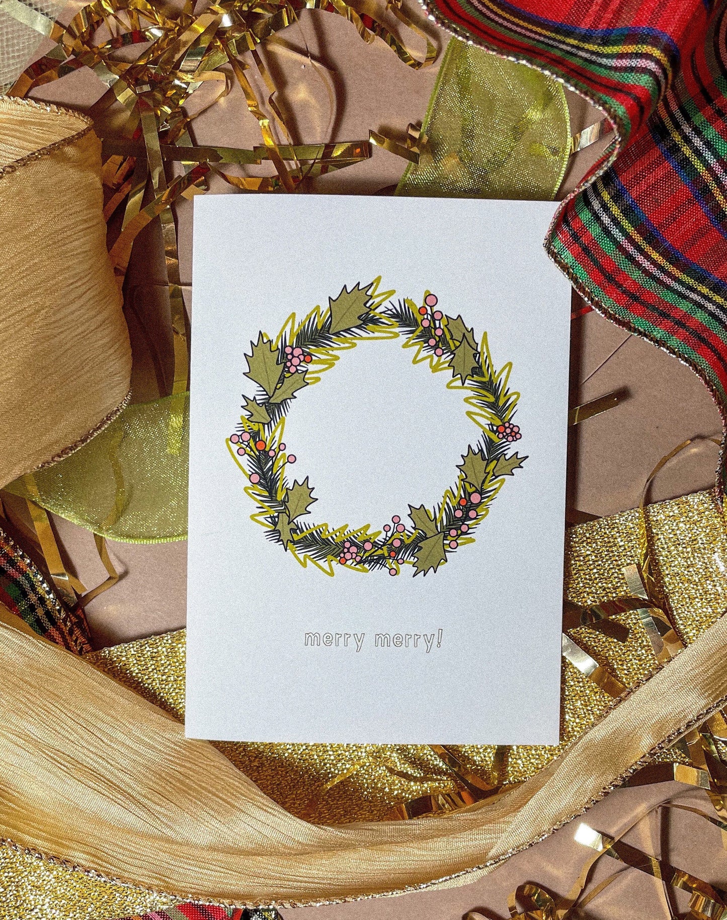 This card features a very merry Christmas wreath with the text 'merry merry!" It's the perfect Christmas card for anyone in your life!