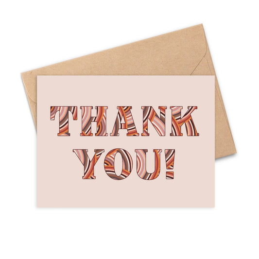 This greeting card is bold and hand-illustrated with beautiful terra cotta colored patterns inside the words "Thank you!". 