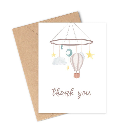 This adorable thank you card has a cute pastel-colored baby hanging mobile - including a hot air balloon, clouds, stars, and moons. The perfect way to say thanks after a baby shower! This illustration was completely hand-drawn and is so cute - unlike anything you'll find at your local store! Your guests will be so touched to receive a hand-written thank you note from you, and they will cherish your thoughtful words.