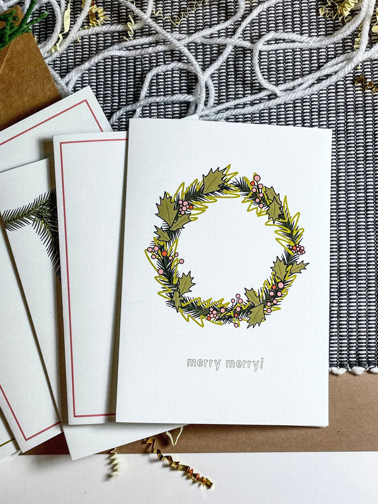 This card features a very merry Christmas wreath with the text 'merry merry!" It's the perfect Christmas card for anyone in your life! 